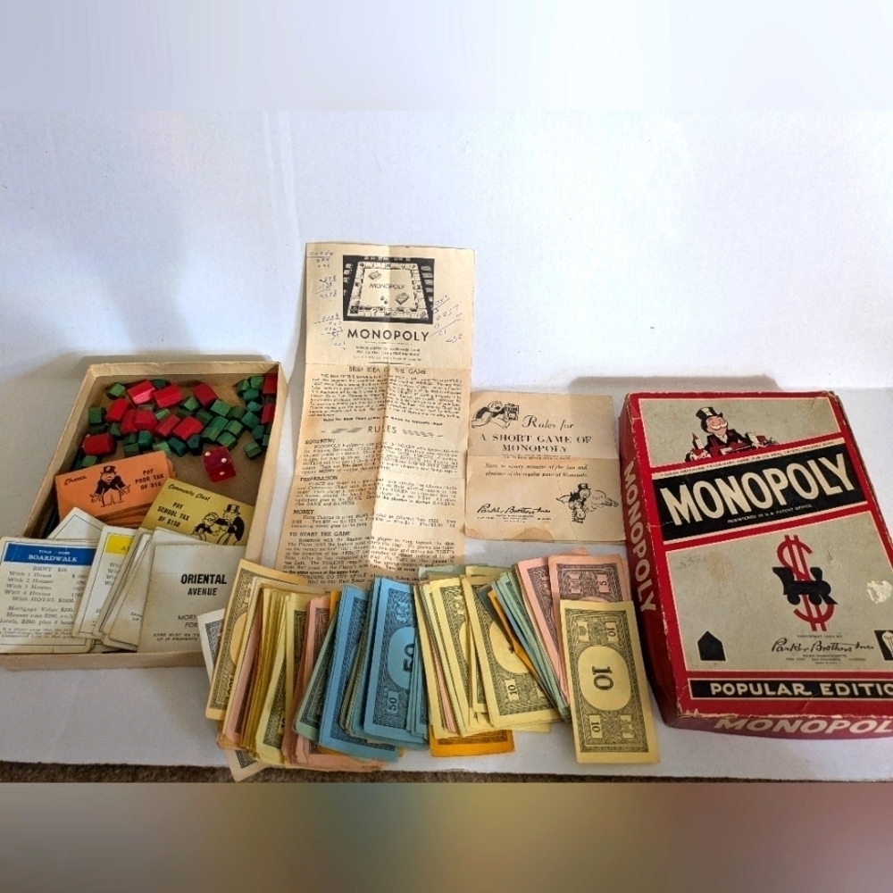 Vintage Monopoly game (1954) with wooden pieces.